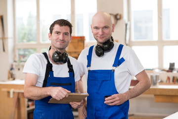 two worker in a carpenter's workshop