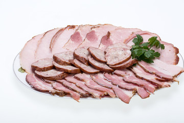 Plate of smoked meat isolated on white background