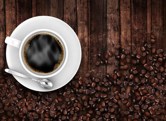 Coffee cup top view with beans on old wooden