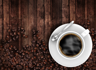 Coffee cup top view with beans on old wooden