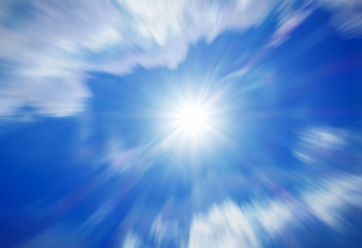 Blurred image of blue-sky with sun for background use