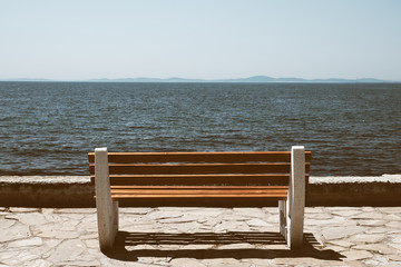 Bench near sea in retro style