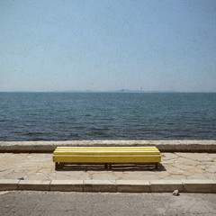 Fototapeta na wymiar Bench on blue sea background in retro style