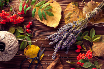 Autumn leaves over wooden background with copy space