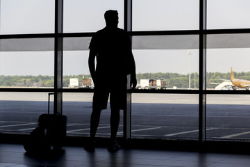 Fototapeta na wymiar silhouette man at airport in front of window