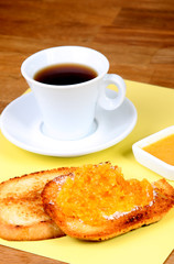 served european breakfast: cup of coffee, toasts and orange jam
