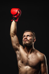 Athletic bearded boxer with gloves on a dark background - 90699622