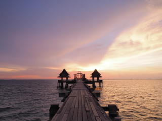 After beautiful sunset, The twilight cloudy sky appear as well as clear ocean around a Temple, Thailand