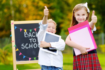 Two adorable little kids going back to school