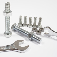 Screw, nut, wrench isolated on white