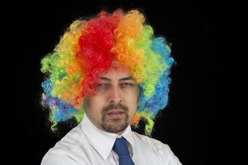 business man wearing colorful wig looking bored