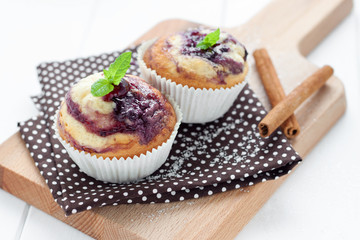 Blueberry muffins on wooden board with cinammon sticks