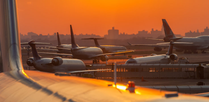 Sunset at the airport with airplanes ready to take off