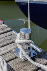  sailor's knots / rope secured to a cleat on the dock