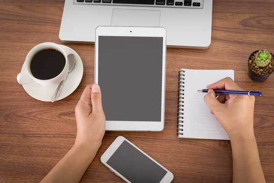 Female Hands Holding A Computer Tablet On The Table In The Offic