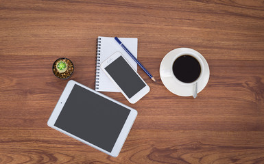 Office table with notepad, coffee cup , pencil,smartphone,tablet