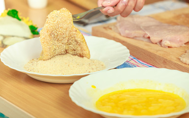 Preparing meal of breaded chicken cutlets