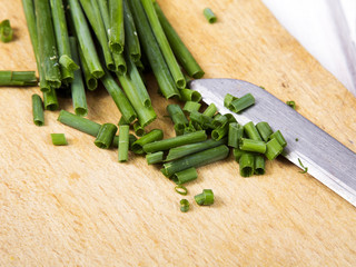 chopped chives on a wooden background