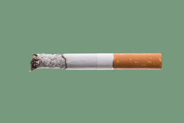 Cigarette burning on green background, quit smoking concept
