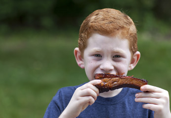 Boy eating rib