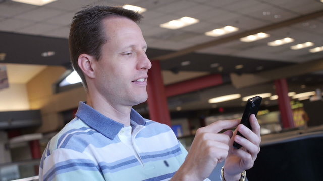 Man with Smartphone in Airport