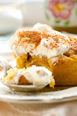 Homemade pumpkin cinnamon rolls with spices and sweet cream