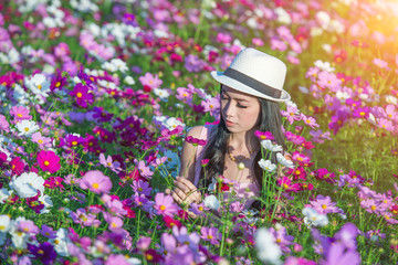 Woman and cosmos flowers.