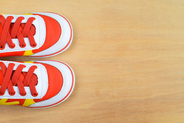 Picture of a pair of kids sport shoes on wood board