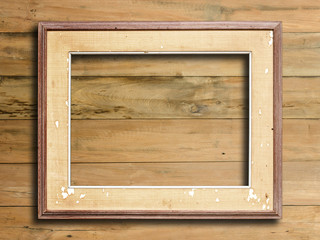 Old picture frame on vintage wood wall.