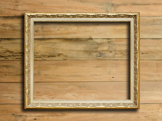 Old picture frame on vintage wood wall.
