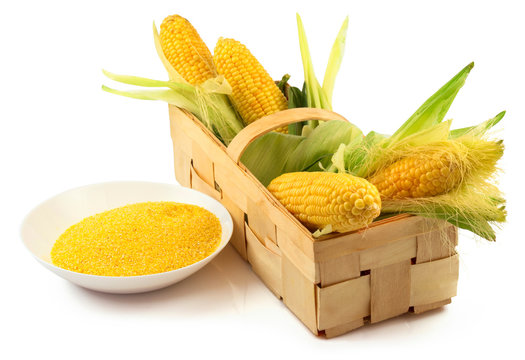 Ripe corn with green leaves in the wooden box and a plate of mai