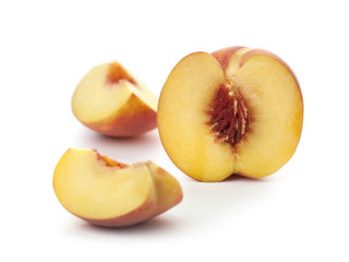 a ripe peach, and two slices of peach