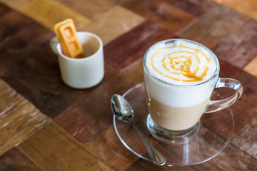 Hot art Latte Coffee in a cup on wooden table, retro and vintage