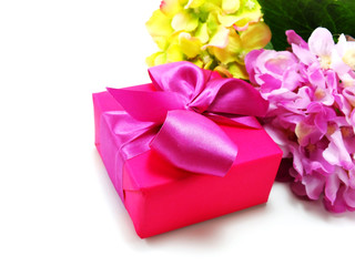 pink present on white background with ribbon and beautiful flower