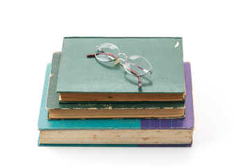 old book with glasses on white background