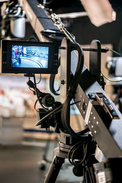 Professional Tripod for camcorder with display in a television studio