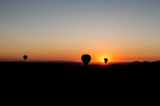 sunset and balloons in cappadocia