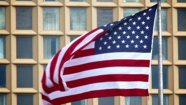 4K American Flag Blowing in front of Office Building 3787