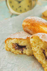 Sweet sugary donuts on rustic table