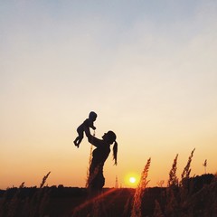 mother and baby family silhouette sunset