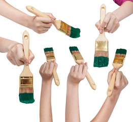 set of hands with flat paint brush with green tips