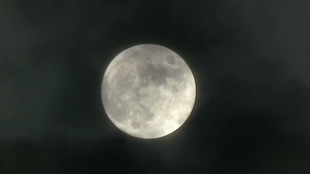 A realtime shot of the full moon on a cloudy night. Not computer generated.	