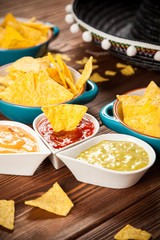 Plate of nachos with different dips