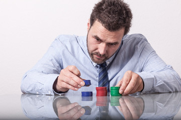 Business man counting stacks of poker chips, gambling. Mature Ca - obrazy, fototapety, plakaty