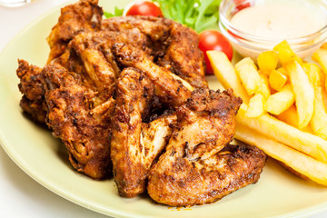 Chicken wings with fries french and spicy sauce