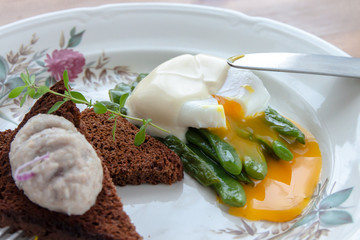 Green beans topped with poached egg closed view