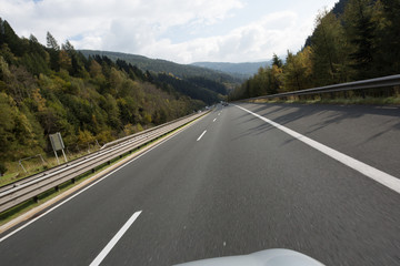 Fototapeta premium Road, green meadows, blue sky