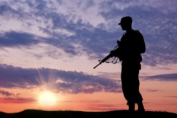 Silhouette of soldier with a gun