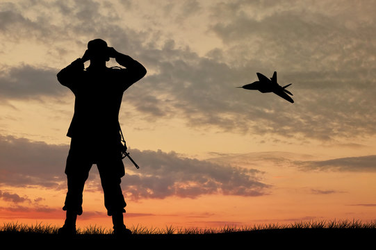Silhouette of a soldier and an airplane