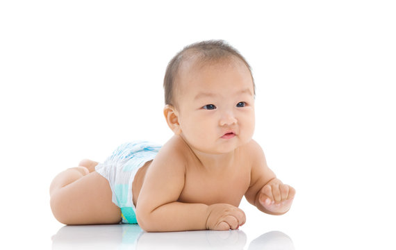 cute asian baby sitting on the floor isolated on white background